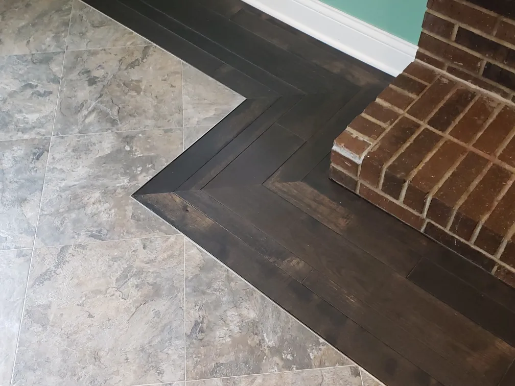 Armstrong Alterna tile to dark hardwood fireplace border  precision mitered transition by 1 Wood Floors Livonia MI