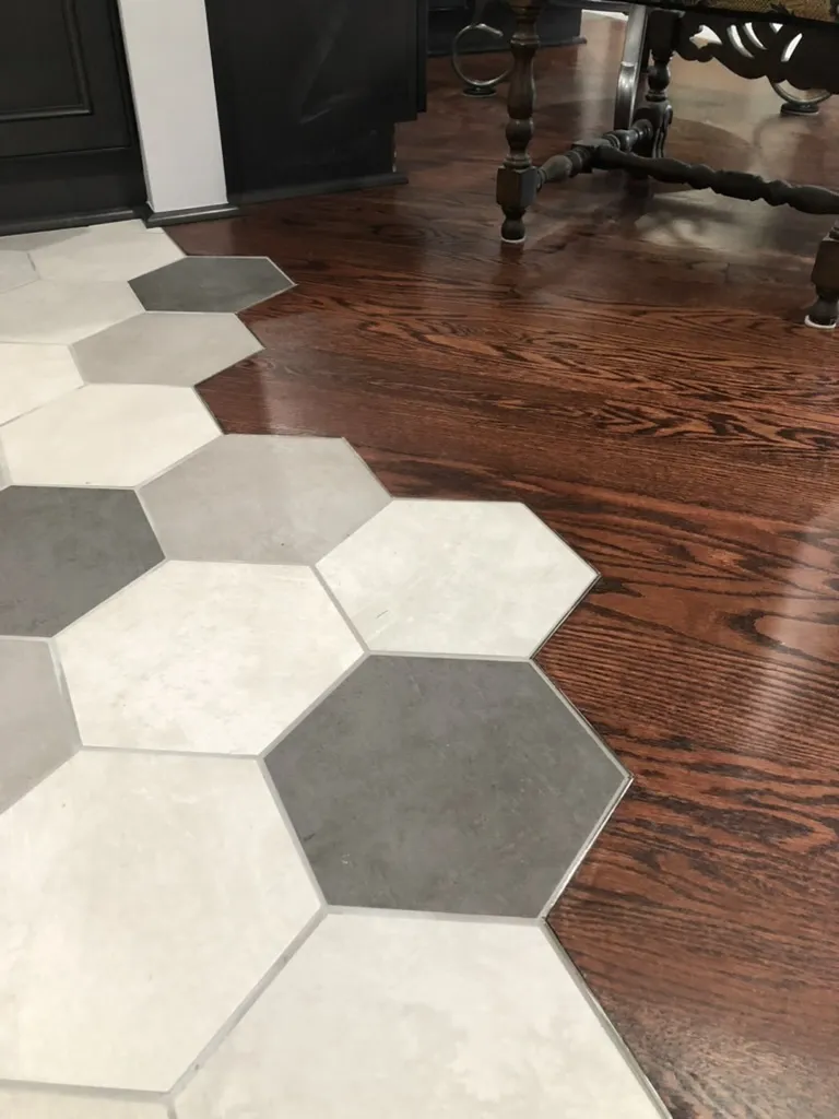Flush hexagon tile to hardwood transition  seamless level flow engineered by 1 Wood Floors Livonia MI