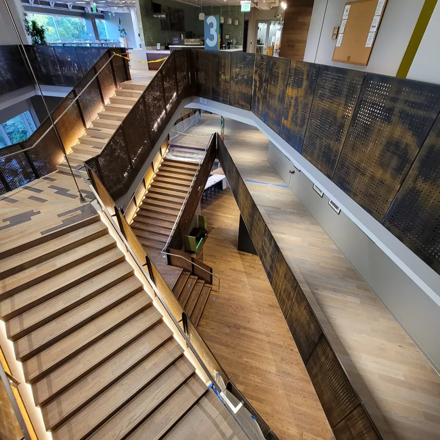 1 Wood Floors  Three-level staircase system with perforated steel railings commercial hardwood Ann Arbor Michigan. Installed by 1 Wood Floors, Livonia, MI