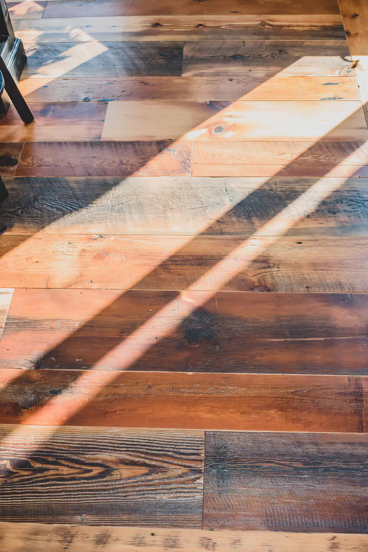 Natural sunlight on reclaimed barnwood floors in Brighton Michigan living space