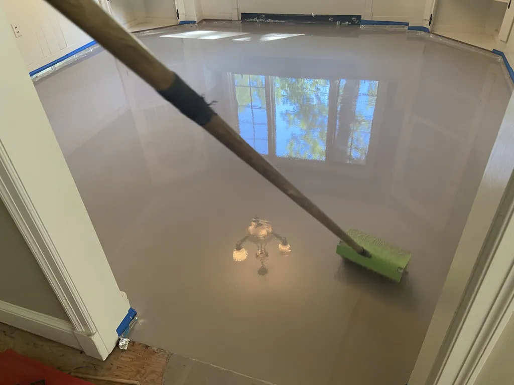 1 Wood Floors  Glossy finish of engineered self-leveling underlayment (SLU) poured over a primed concrete subfloor to achieve NWFA flatness tolerances in Livonia. Installed by 1 Wood Floors, Livonia, MI