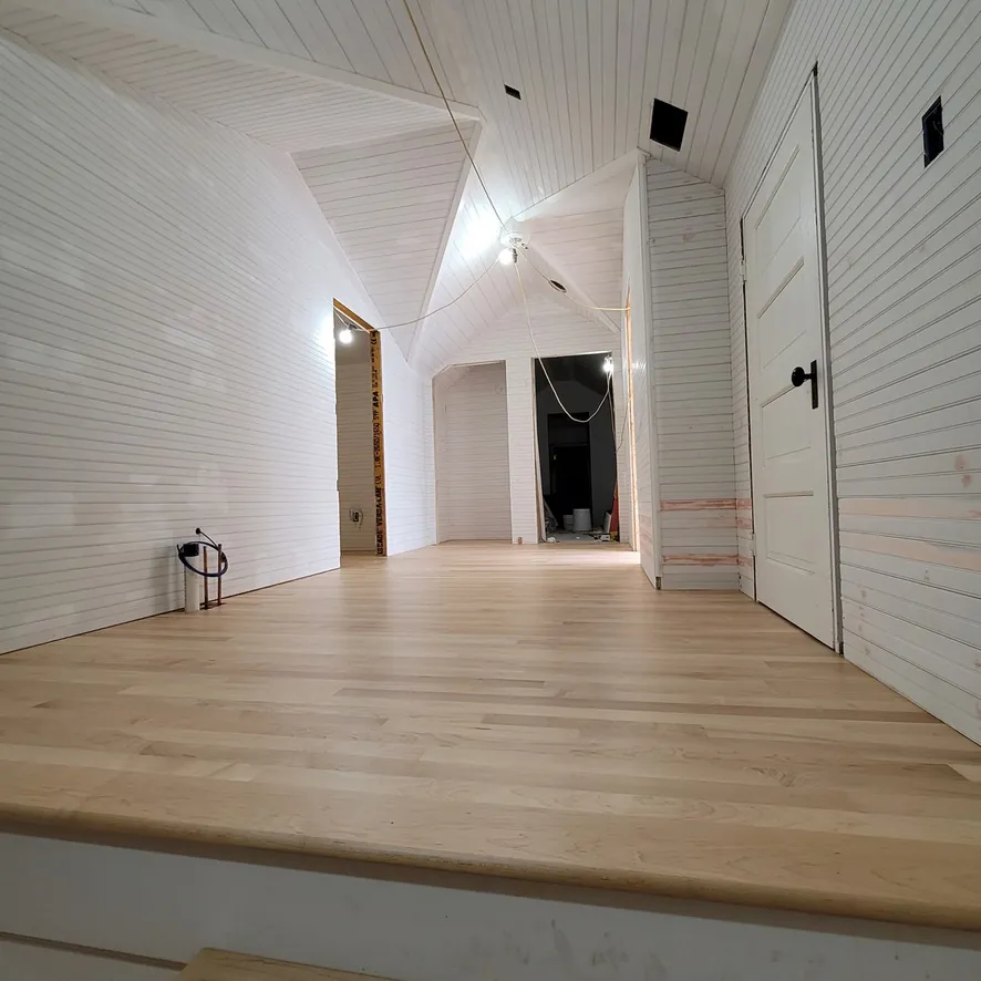 1 Wood Floors  Vaulted hallway with invisible-finish maple flooring  Harbor Springs MI  Installed by 1 Wood Floors, Livonia, MI