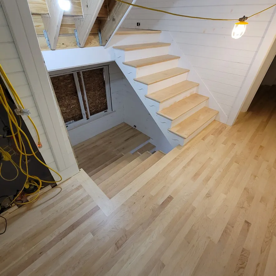1 Wood Floors  Maple staircase with invisible zero-sheen finish and custom handrail  Harbor Springs MI  Installed by 1 Wood Floors, Livonia, MI