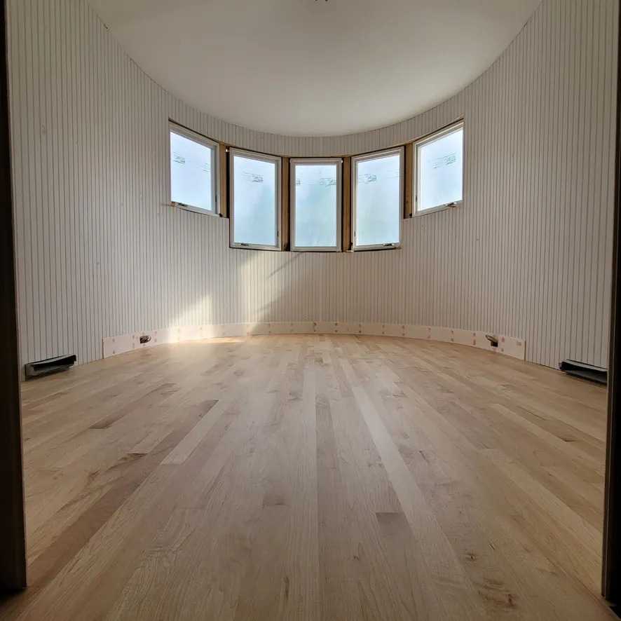 1 Wood Floors  Invisible finish Maple flooring in curved turret bay window room  Harbor Springs MI  Installed by 1 Wood Floors, Livonia, MI