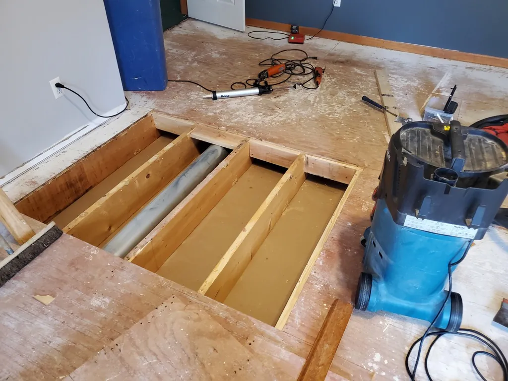 1 Wood Floors  Carpenter inspecting and repairing floor joists to correct structural dips in a Metro Detroit home