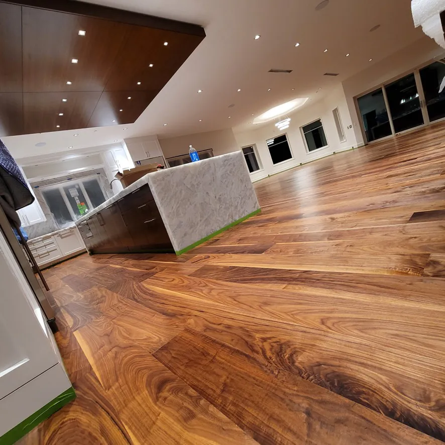Custom walnut wide-plank flooring flowing through kitchen with center island  Northville MI  1 Wood Floors
