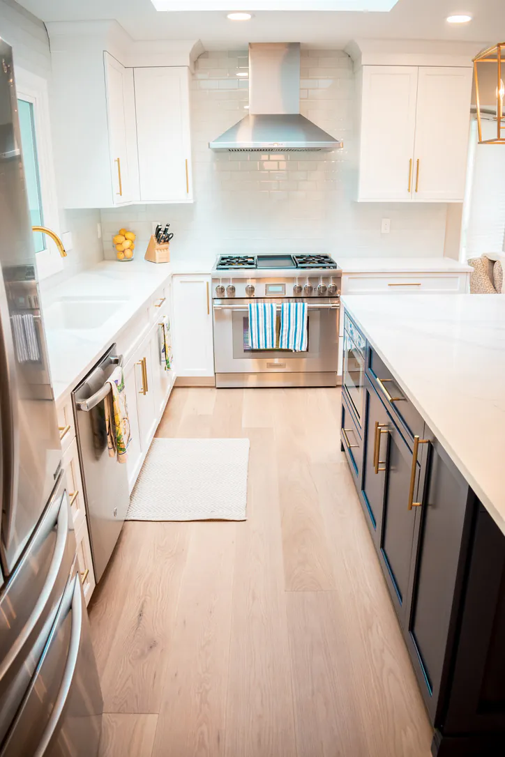 1 Wood Floors  Gourmet kitchen with custom 8-inch White Oak flooring navy cabinetry and professional range. Plymouth MI. Installed by 1 Wood Floors, Livonia, MI