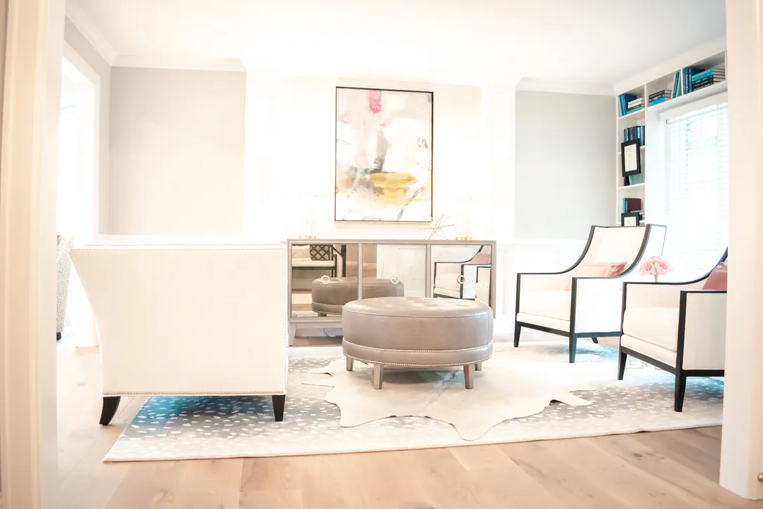 1 Wood Floors  8-inch White Oak wide-plank flooring in designer living room with contemporary art and mirrored credenza. Plymouth MI. Installed by 1 Wood Floors, Livonia, MI
