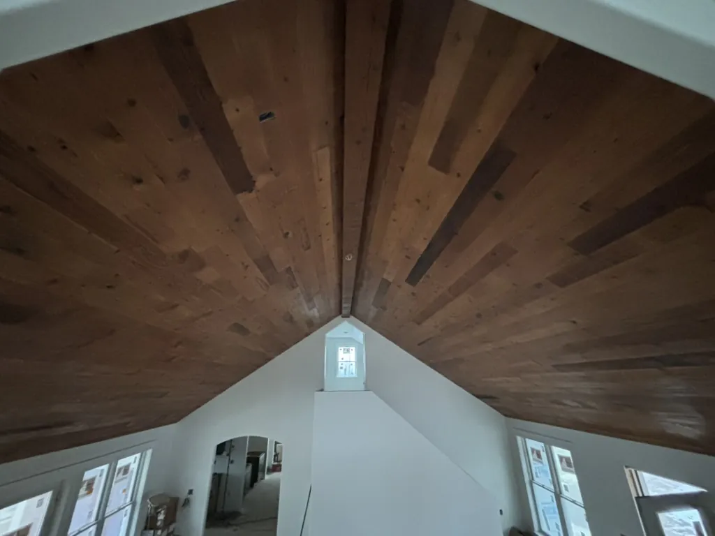 1 Wood Floors  Reclaimed Douglas Fir cathedral ceiling with fabricated beam. Lexington, Michigan. Installed by 1 Wood Floors, Livonia, MI
