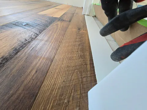 1 Wood Floors  Reclaimed antique oak closeup showing original saw marks. Random 4–8 inch widths, oil finish. Lexington, Michigan. Installed by 1 Wood Floors, Livonia, MI
