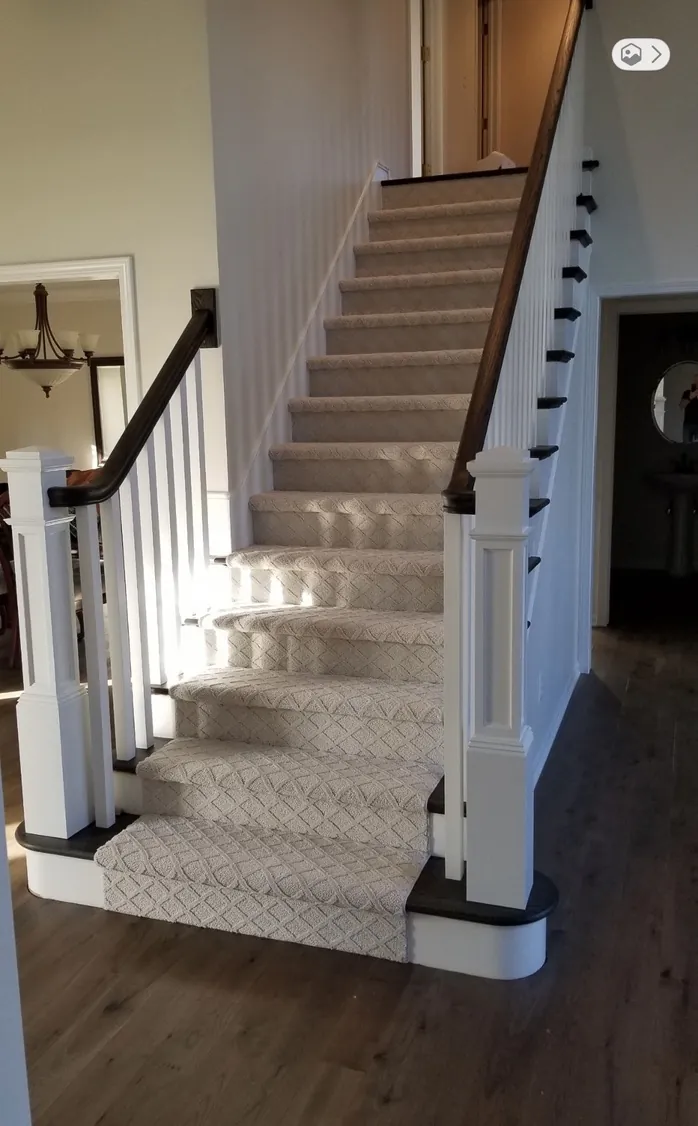 Custom Hickory Sparks flooring matched with a renovated staircase featuring a Dreamweaver Select carpet runner in Brighton, MI by 1 Wood Floors