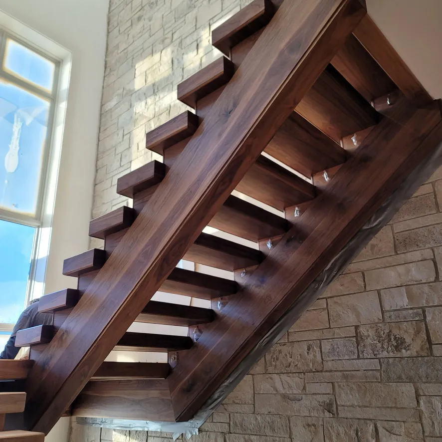 Custom solid Walnut floating staircase and 8-inch wide-plank FAS Walnut flooring finished with Pallmann Magic Oil in Northville, Michigan by 1 Wood Floors