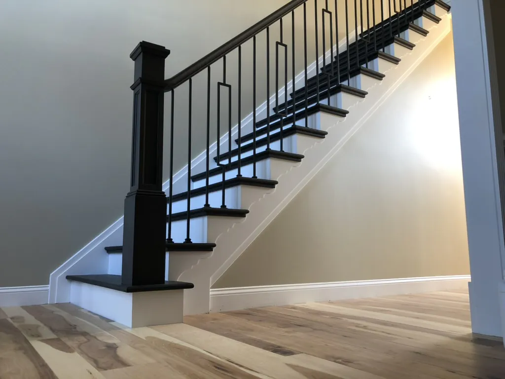 Custom Hickory flooring matched with Sable Black and White high-contrast staircase in Northville, Michigan by 1 Wood Floors